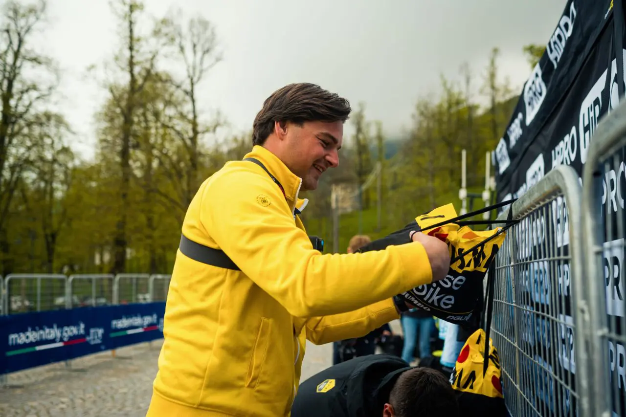 A TvL rider signs merchandise, available at the Giro d'Italia 2026